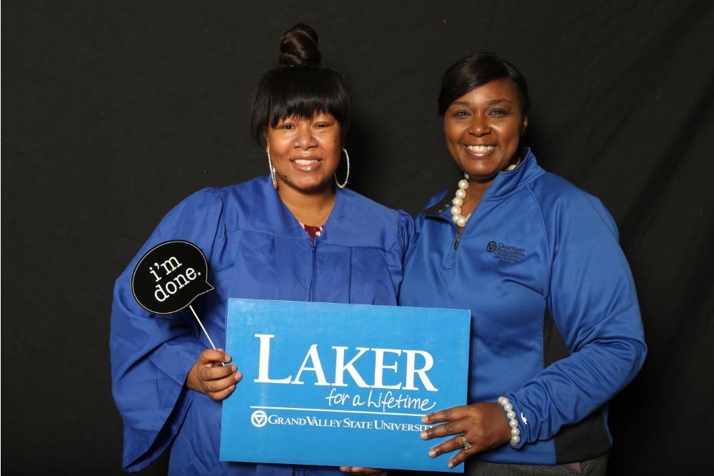 two women holding up laker for a lifetime sign